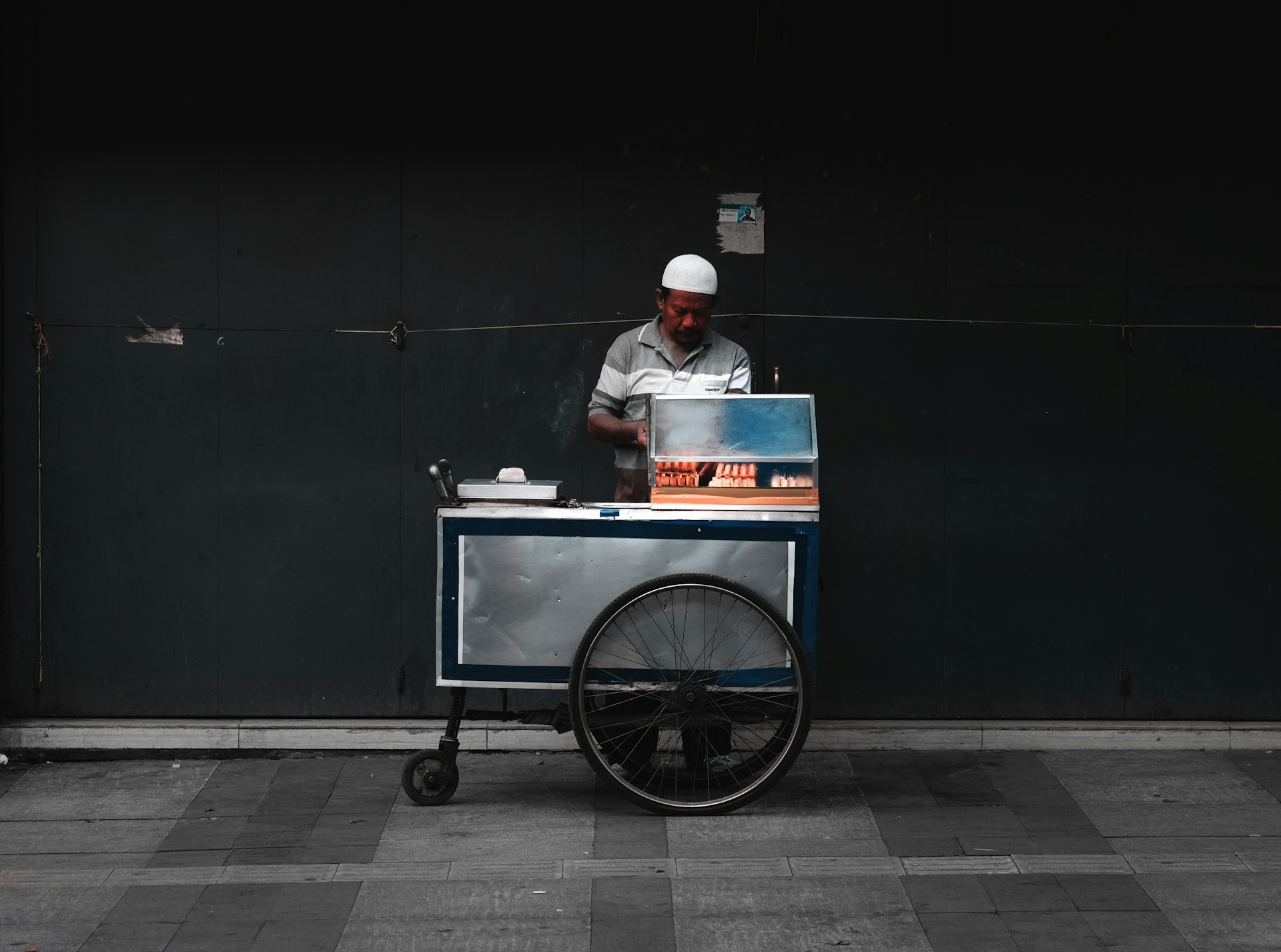 man vending food near wall during daytime